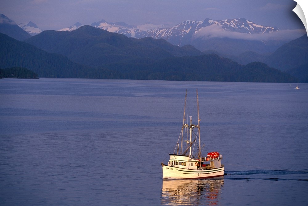 USA, Alaska, Sitka. A fishing boat returns to Sitka, Baranof Island behind.