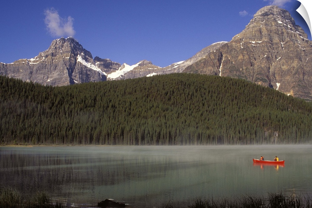 Two boys fishing from a red canoe in Waterfowl Lake, in Canada's Banff national park.