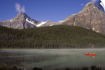 Alberta, Banff National Park, Boys fishing from a red canoe in Waterfowl Lake