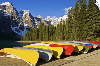 Alberta, Banff National Park, Moraine Lake and rental canoes stacked on shore