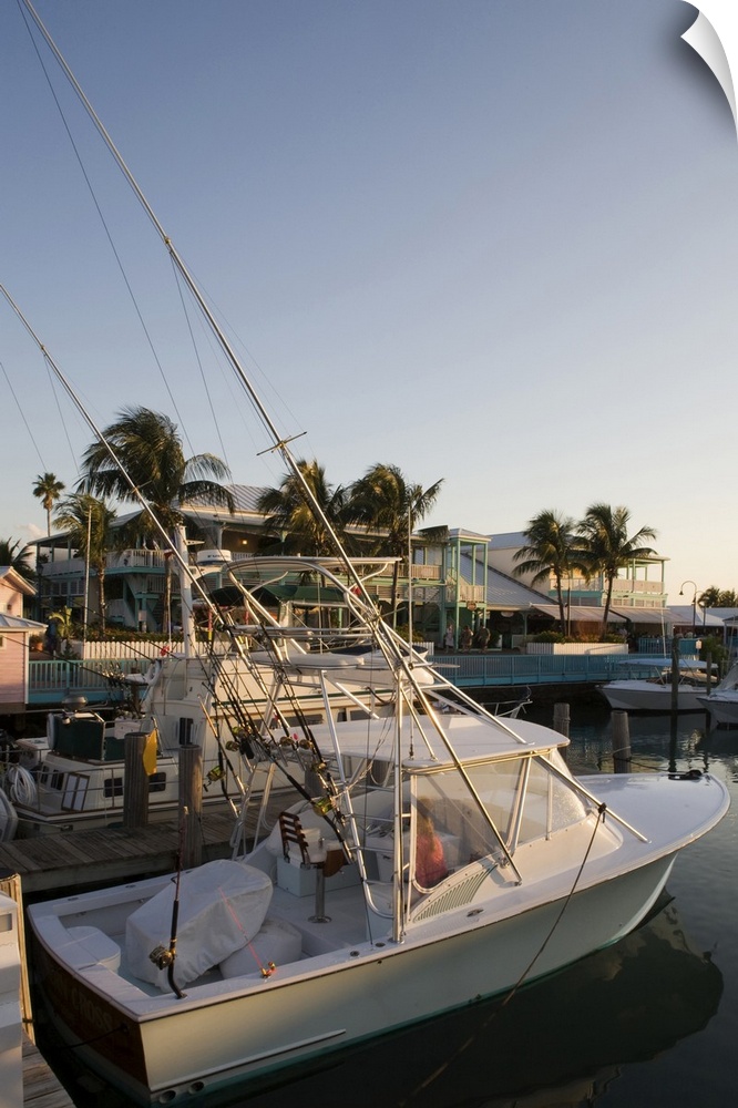 Bahamas, Grand Bahama Island, Freeport, Setting sun lights power boats at marina near Our Lucaya Resort