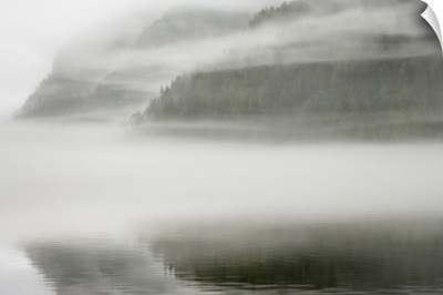 British Columbia, Calvert Island, Mist and fog shroud water and forested island
