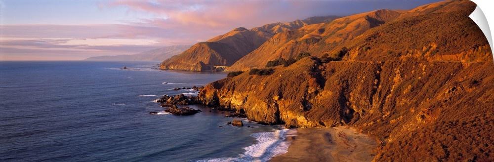 USA, California, Big Sur. Sunset casts a golden hue over the Coast Range near Big Sur, on Highway 1 in central California.