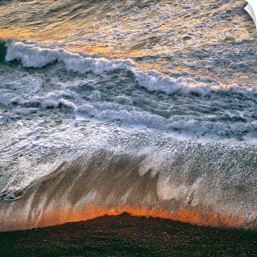 USA, California, Big Sur. Breaking surf catches the late fiery light of sunset at Big Sur on the California coast.