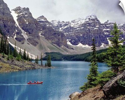 Canada, Alberta, a canoe glides across Moraine Lake in the Valley of the Ten Peaks