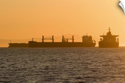 Cargo ship silhouettes in English Bay Beach, Vancouver, Canada