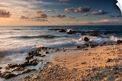 Caribbean Sea, Cayman Islands. Crashing waves at sunset on the shore