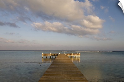 Cayman Islands, Little Cayman Island, Setting sun lights wooden boat pier