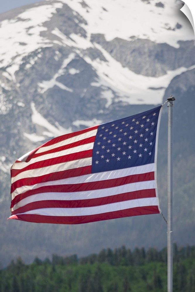 USA, Colorado, Silverthorne. American flag flying against mountain backdrop.