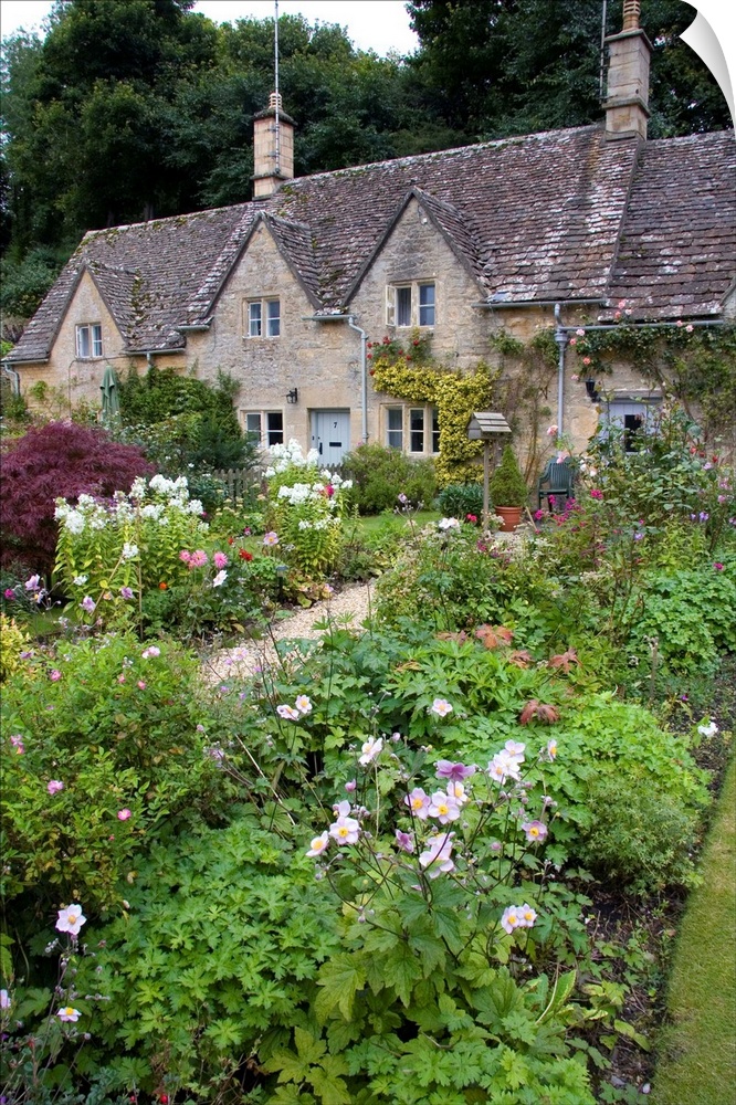 Cotswold stone cottage and garden in Bibury, Gloucestershire, England.