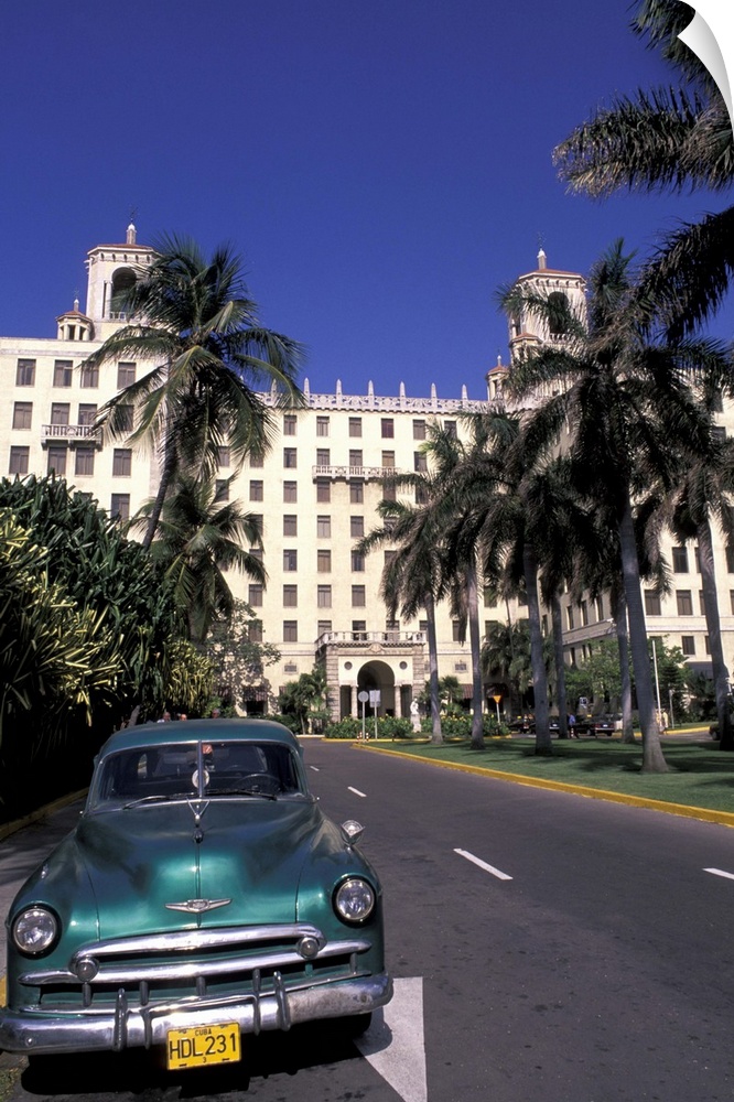 Cuba, Havana.  Classic 1950's auto in front of Habana Nacional Hotel.