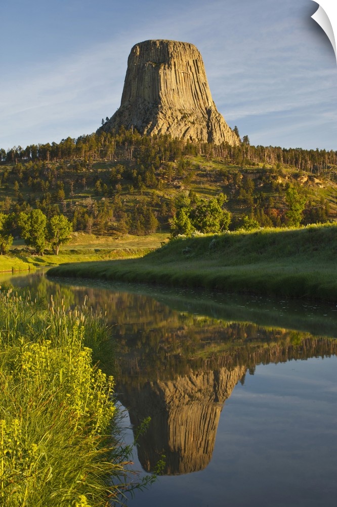 Devil's Tower National Monument, Wyoming, reflected in Belle Fourche River at sunrise.