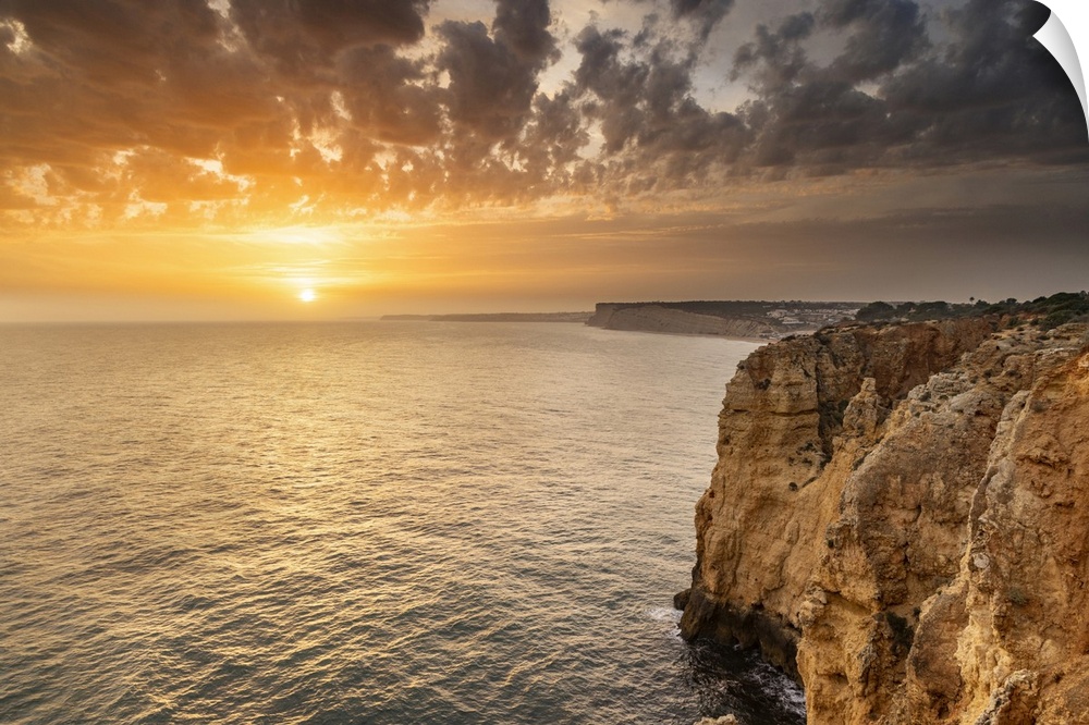 Dramatic sunset clouds over Cliffs along the coast at Ponta da Piedade in Lagos, Portugal.