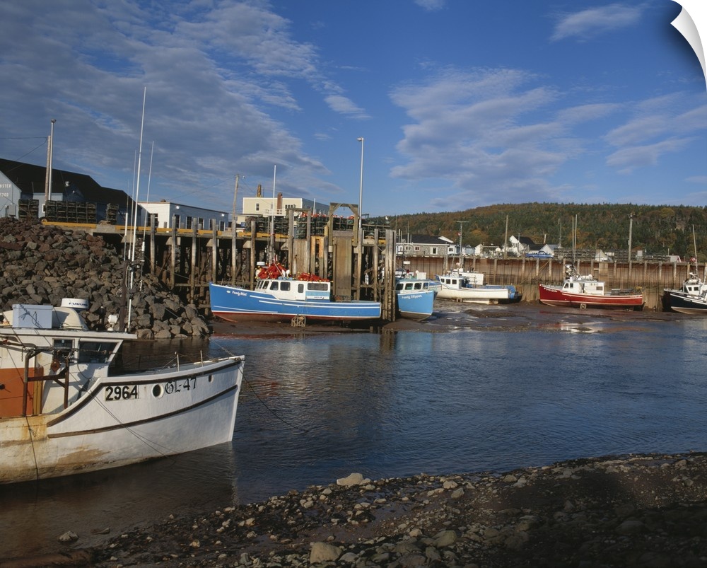 Fishing boats docked at low at in the Bay of Fundy town of Alma, New Brunswick, Canada