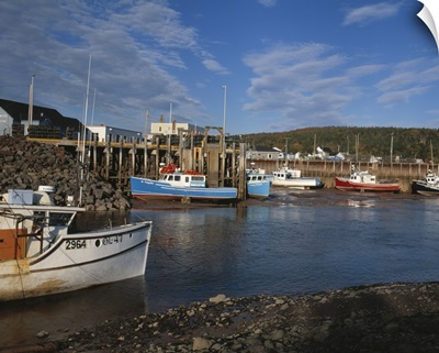 Fishing boats docked at low at in the Bay of Fundy town of Alma, New Brunswick