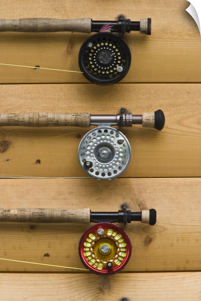 USA, Alaska, Silver Salmon Creek Lodge. Fishing rods wait for customers on the wall of the lodge.