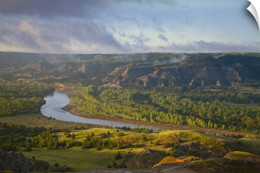 Fog burns off at sunrise from River Bend Overlook in the North Unit of Theodore Roosevelt National Park, North Dakota, USA
