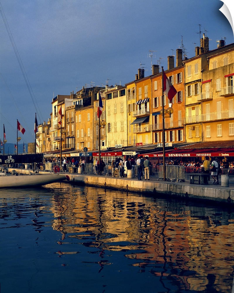 Europe, France, St. Tropez. The cafes along the harbor are filled with people-watchers in St. Tropez on the Riviera in Fra...