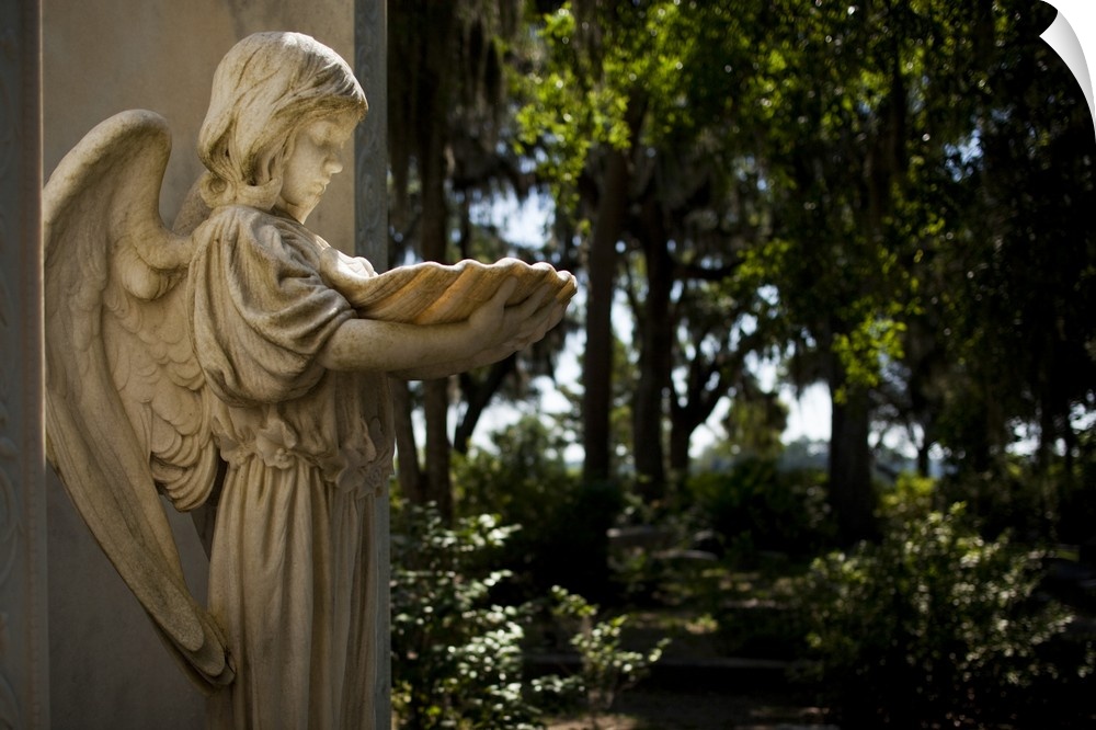 USA, Georgia, Savannah, Graveyard statue of angel inside Bonaventure Cemetery on summer morning.