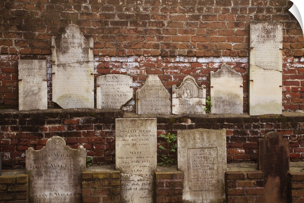 North America, USA, Georgia, Savannah, Tombstones on a wall in Historic Colonial Park Cemetery.