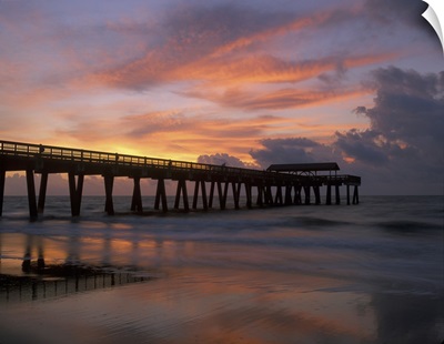 Georgia Tybee Island, pier at sunrise with reflections of clouds on beach
