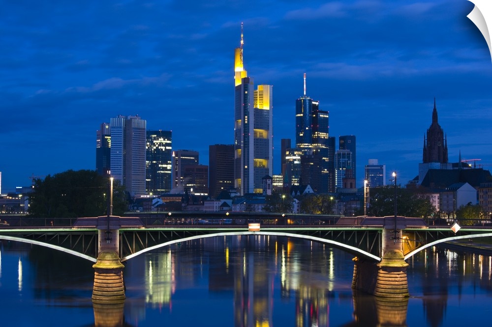 GERMANY, Hessen, Frankfurt am Main. Skyline from Main River and Ignatz Bubis Brucke bridge, dawn.