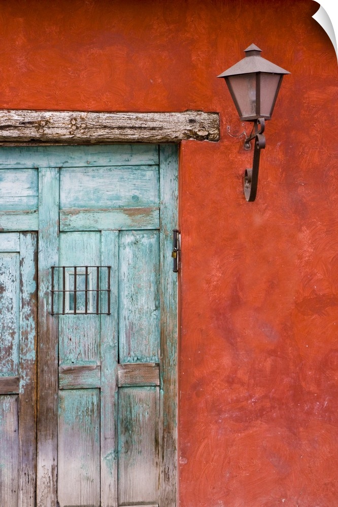 Central America, Guatemala, Antigua.  Aqua blue door against colorful red wall in Antigua.