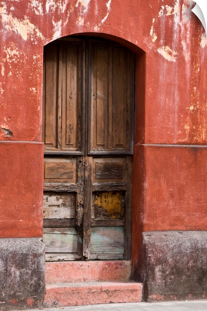 Central America, Guatemala, Antigua.  Exterior wall and wooden door along the streets of Antigua.