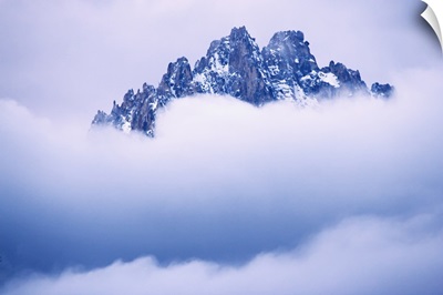 Idaho, Sawtooth Range. Mountain top peaks through the heavy clouds