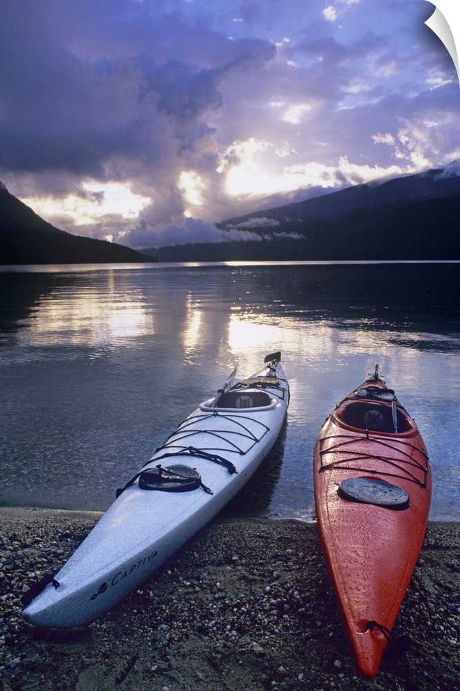 Kayaks at sunset on Rainbow Falls Beach on Azure Lake in Wells Gray Provincial Park, British Columbia, Canada.