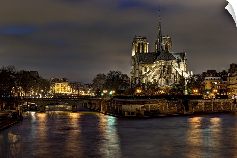Notre dame cathedral and the seine river shimmer in the Paris, France. Night.