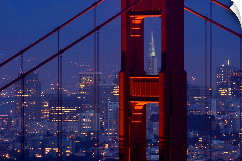 A dusk view of San Francisco with the Transamerica building through the Golden Gate Bridge.
