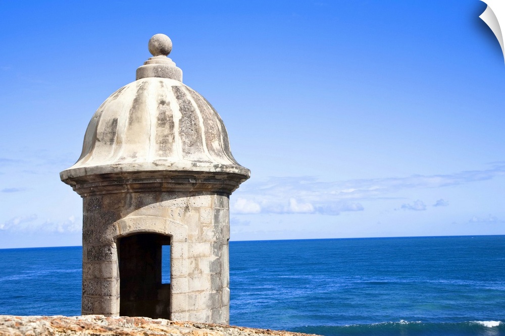 San Juan, Puerto Rico - An old stone watchtower looks out over the ocean. Horizontal shot.