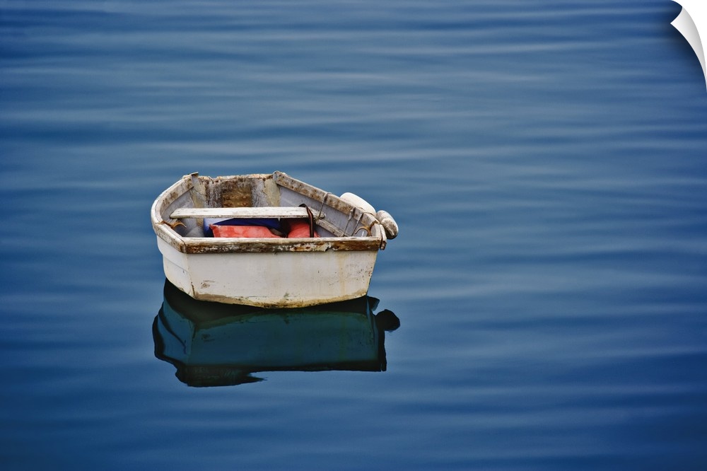 Single small boat floating on ocean, Maine