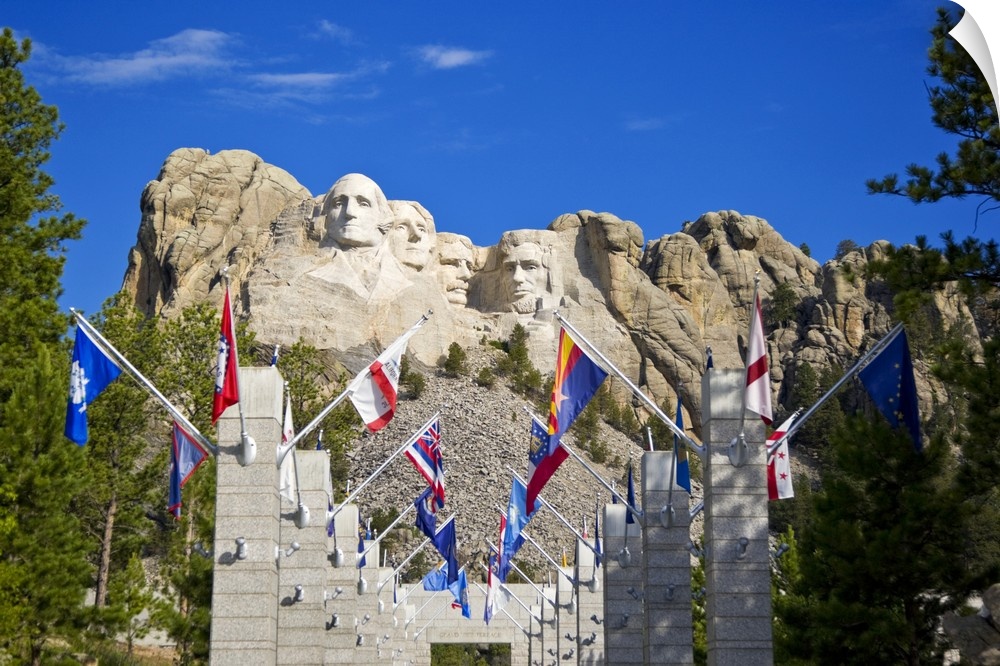 USA, South Dakota, overview of Mount Rushmore National Memorial in daytime, framed by Grand View Terrace with flags in for...
