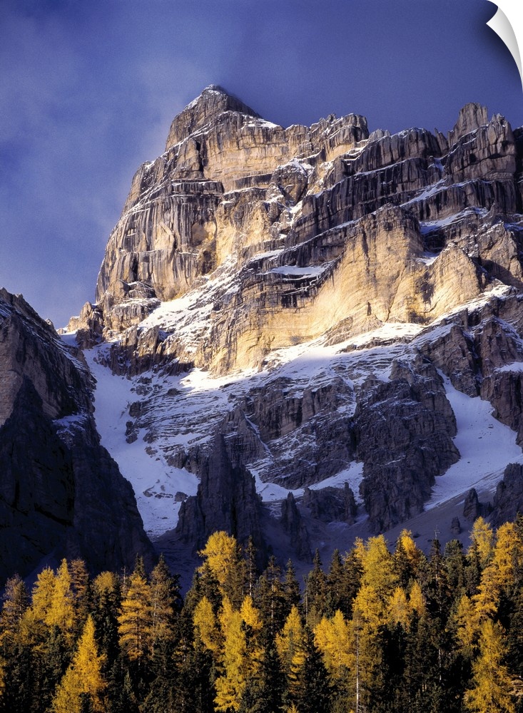 Europe, Italy, Sella Mountains. Sunlight washes a craggy peak near the Sella Group, in Italy's Dolomite Alps.