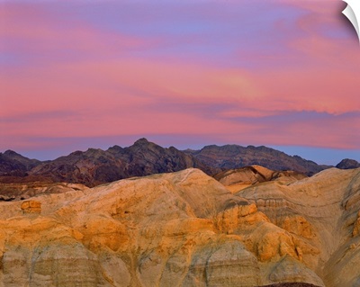 Sunset colors the sky with vibrant pink and purple in Death Valley, California