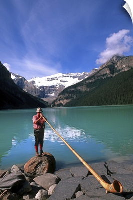 Swiss Alphorn player at Lake Louise in Banff, Canada