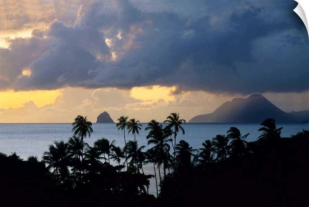 The sun sets behind Diamond Rock viewed from the island of Martinique in the Caribbean Sea.