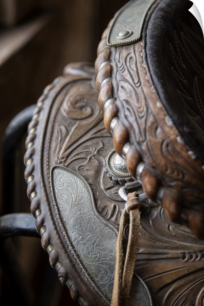 USA, Colorado, Custer County, Westcliffe, Music Meadows Ranch. Tack room. Tooled leather western saddle. United States, Co...
