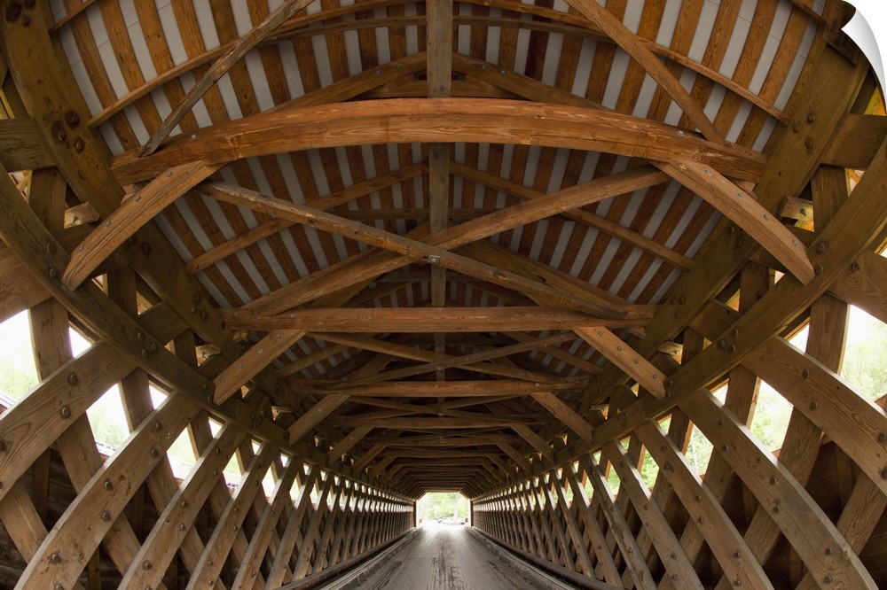 USA, Vermont, Bennington, patterns of wooden beams inside Paper Milll Covered Bridge on a spring morning.