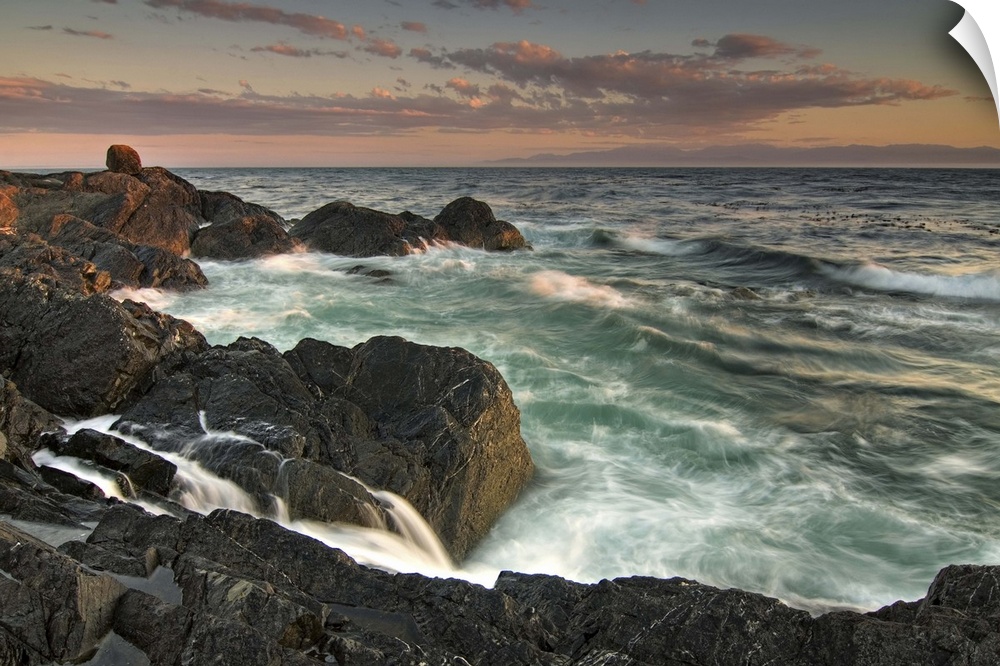 USA, Washington, San Juan Islands. Waves crash on the southern shore of Lopez Island at sunset.