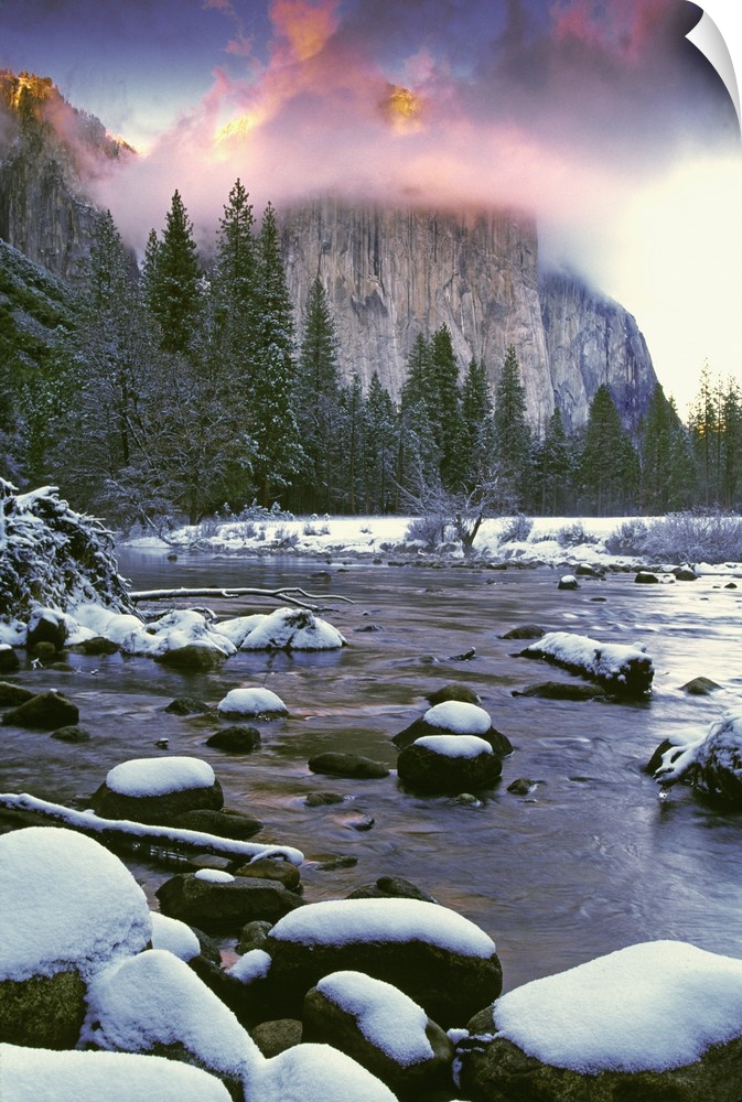 USA, California, Yosemite National Park. Sunlight on clouds over El Capitan as seen from the Merced River in winter.