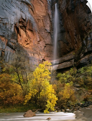 Zion National Park, Utah, waterfall pours over cliff above Virgin River