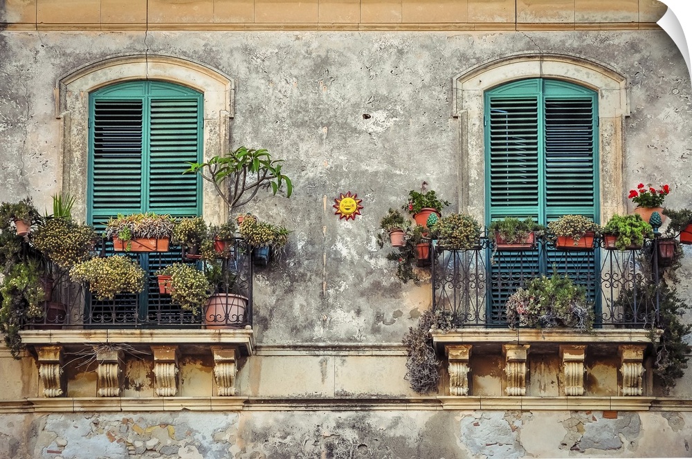 Beautiful vintage balcony with colorful flowers and wooden doors, Mediterranean style.