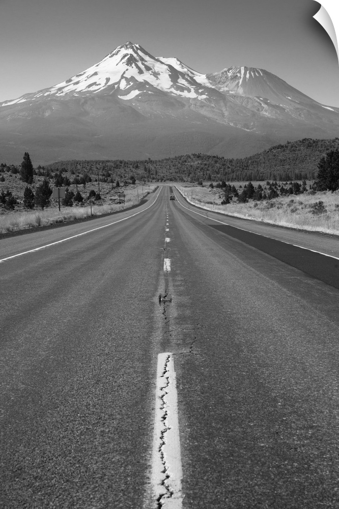Two lane road heads west across California mountain landscape.