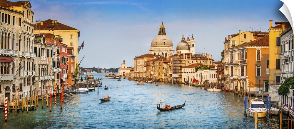 Panoramic view of famous canal grande and Basilica Di Santa Maria Della salute in golden evening light at sunset in Venice...