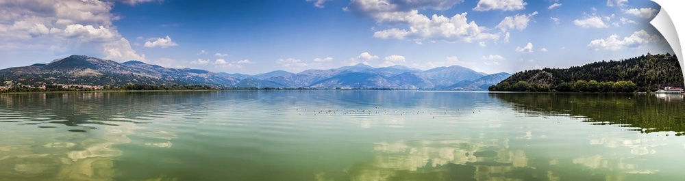 Panoramic view of Kastoria lake under blue sky, Greece.