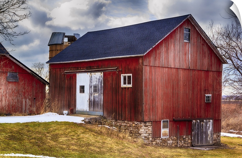 Large red bank barn. New roof. Crisp colors and overcast sky.