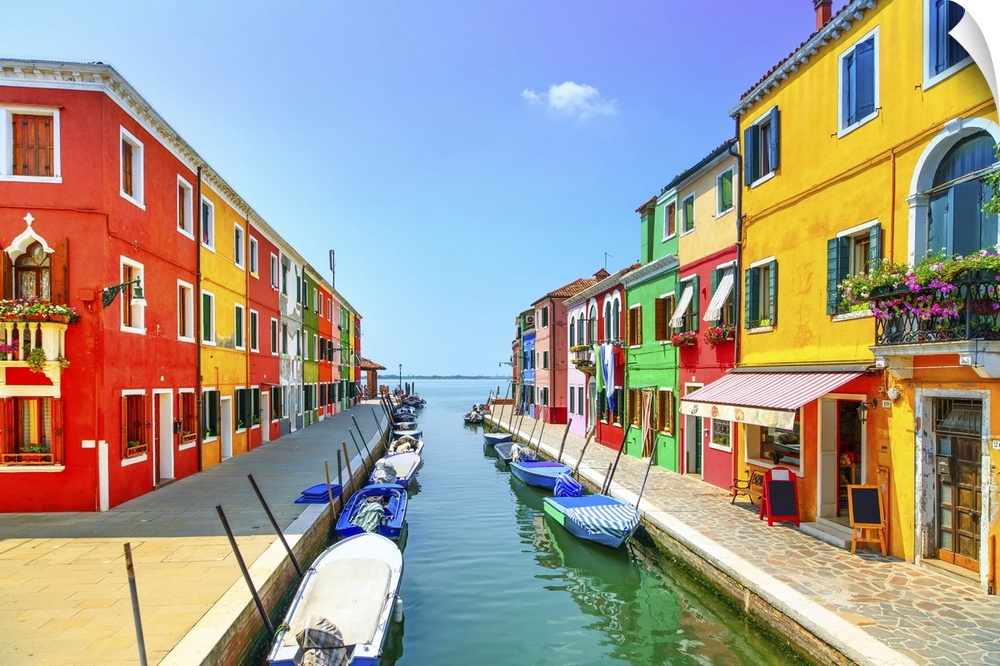 Venice landmark, Burano island canal, colorful houses and boats, Italy. Long exposure photography.